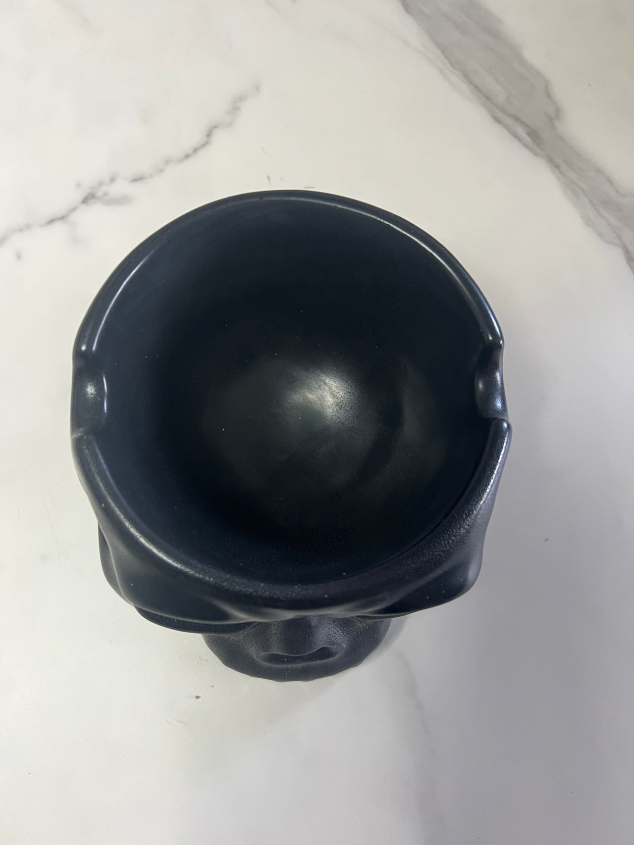 A - concrete black skull cigar bowl